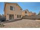 Gravel backyard featuring block wall, sliding door access, and potential for landscaping at 4832 Englewood Ave, Las Vegas, NV 89139