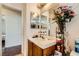 Bathroom featuring single sink vanity, framed mirror, and decorative touches at 4832 Englewood Ave, Las Vegas, NV 89139