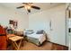 Modest bedroom with a ceiling fan, side table, and neutral colored walls at 4832 Englewood Ave, Las Vegas, NV 89139