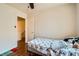 Bedroom with wood floors, ceiling fan, and access to an adjacent hallway at 4832 Englewood Ave, Las Vegas, NV 89139
