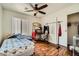 Bedroom with wood floors, ceiling fan, natural light from window, and closet at 4832 Englewood Ave, Las Vegas, NV 89139