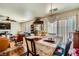 Dining area with crystal chandelier and open access to the living room with fireplace at 4832 Englewood Ave, Las Vegas, NV 89139