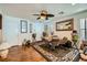 Dining area features wood floors, a ceiling fan, a patterned rug, and bright natural light at 4832 Englewood Ave, Las Vegas, NV 89139