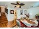 Inviting dining area with wood floors, ceiling fan, and staircase access at 4832 Englewood Ave, Las Vegas, NV 89139