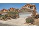 Inviting home exterior with a wide driveway, desert landscaping, and a well-maintained two-car garage at 4832 Englewood Ave, Las Vegas, NV 89139