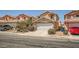 Home exterior featuring a two-car garage, a well-maintained lawn, and serene neighborhood vibes at 4832 Englewood Ave, Las Vegas, NV 89139