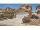 Comfortable home featuring a two-car garage, tidy landscaping, and a welcoming facade at 4832 Englewood Ave, Las Vegas, NV 89139