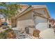 Home exterior showcasing a two-car garage and a landscaped entrance at 4832 Englewood Ave, Las Vegas, NV 89139