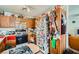 Compact kitchen with wood cabinets, appliances, and creative decor on the fridge at 4832 Englewood Ave, Las Vegas, NV 89139