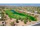 Aerial view of the golf course and community featuring ponds, green fairways, and lush landscaping at 4845 Santo Romeo St, Las Vegas, NV 89135