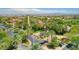 Beautiful aerial view of the community featuring lush greenery, palm trees and a clock tower at 4845 Santo Romeo St, Las Vegas, NV 89135