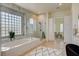 Bright bathroom showcasing tub, and glass enclosed shower, designed for a relaxing and spa-like atmosphere at 4845 Santo Romeo St, Las Vegas, NV 89135