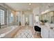 Bright bathroom featuring double vanity sinks, a soaking tub, and glass enclosed shower for a spa-like experience at 4845 Santo Romeo St, Las Vegas, NV 89135