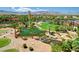 An aerial photograph features a lush community park with a serene pond and a charming walking bridge at 4845 Santo Romeo St, Las Vegas, NV 89135