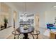 Bright dining area with modern light fixtures and open floor plan with a view of the kitchen at 4845 Santo Romeo St, Las Vegas, NV 89135