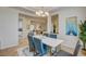 Inviting dining room featuring modern decor, an elegant chandelier, and a view into the living area at 4845 Santo Romeo St, Las Vegas, NV 89135