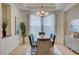 Elegant dining room with a modern chandelier, large window, and stylish furnishings at 4845 Santo Romeo St, Las Vegas, NV 89135