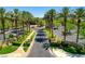 Beautiful entrance featuring lush greenery, palm trees and brick paved roads at 4845 Santo Romeo St, Las Vegas, NV 89135