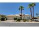Inviting single-story home featuring a three-car garage, a tile roof, palm trees, and well-manicured landscaping at 4845 Santo Romeo St, Las Vegas, NV 89135