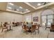 Bright game room area features several tables and comfortable seating with views of the adjacent pond at 4845 Santo Romeo St, Las Vegas, NV 89135