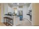 Stylish kitchen boasts a breakfast bar, white cabinets, and granite countertops at 4845 Santo Romeo St, Las Vegas, NV 89135