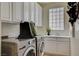 Well-equipped laundry room with ample storage and modern washer and dryer at 4845 Santo Romeo St, Las Vegas, NV 89135