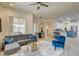 Bright and open living space with a comfortable sectional, modern furnishings, and a view of the dining area and kitchen at 4845 Santo Romeo St, Las Vegas, NV 89135