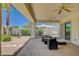 Comfortable covered patio with ceiling fans and outdoor seating, beautiful backyard at 4845 Santo Romeo St, Las Vegas, NV 89135