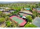 Aerial view of well-maintained tennis courts, a verdant golf course, and lush landscaping define this community at 4845 Santo Romeo St, Las Vegas, NV 89135