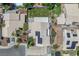 Bird's eye view of home with solar panels, lush backyard with green lawn, and mature trees at 4871 La Princesa Ct, North Las Vegas, NV 89031