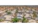 Overhead shot of a planned community features neat rows of houses, mature trees, and lush vegetation at 4871 La Princesa Ct, North Las Vegas, NV 89031
