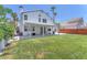 Spacious backyard featuring lush green grass, a covered patio and mature trees at 4871 La Princesa Ct, North Las Vegas, NV 89031