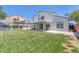 Beautiful backyard with lush grass, mature trees, covered patio, and privacy fence at 4871 La Princesa Ct, North Las Vegas, NV 89031