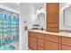 Bright bathroom with a vanity with integrated storage, alongside a shower with a patterned curtain at 4871 La Princesa Ct, North Las Vegas, NV 89031