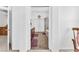 Hallway view into the bathroom featuring double sinks, walk in shower, and doors at 4871 La Princesa Ct, North Las Vegas, NV 89031