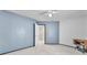 Spacious bedroom with neutral carpeting and blue accent wall at 4871 La Princesa Ct, North Las Vegas, NV 89031
