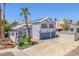 Two-story home featuring a well-manicured lawn, an attached two-car garage, and a classic stucco facade at 4871 La Princesa Ct, North Las Vegas, NV 89031