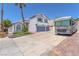 Two-story home with a two-car garage, a well-manicured lawn, and an RV parked in the driveway at 4871 La Princesa Ct, North Las Vegas, NV 89031