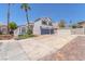 Two-story home featuring a two-car garage, a well-manicured lawn and palm trees on a sunny day at 4871 La Princesa Ct, North Las Vegas, NV 89031