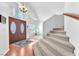 Grand foyer with staircase, chandelier, and decorative entry doors at 4871 La Princesa Ct, North Las Vegas, NV 89031