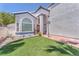 Inviting home featuring manicured grass, trimmed shrubbery, and a cozy front entrance on a sunny day at 4871 La Princesa Ct, North Las Vegas, NV 89031
