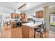 Bright kitchen featuring an island with bar seating, wood cabinets, and views to the patio at 4871 La Princesa Ct, North Las Vegas, NV 89031