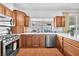 Spacious kitchen features stainless steel appliances, wood cabinets, and a large sink overlooking the backyard at 4871 La Princesa Ct, North Las Vegas, NV 89031