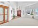 Bright living room featuring large windows, neutral walls, and elegant decor with hardwood-style flooring at 4871 La Princesa Ct, North Las Vegas, NV 89031