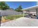 Covered patio with ample space, overlooking a backyard with green grass at 4871 La Princesa Ct, North Las Vegas, NV 89031