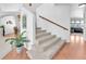 Bright staircase with wood and carpet steps leading to a home's upper level with view to other rooms at 4871 La Princesa Ct, North Las Vegas, NV 89031