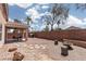 Large backyard with gravel, covered patio, fire pit, and hardscape at 5043 Naff Ridge Dr, Las Vegas, NV 89131