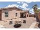 Spacious backyard with gravel, hardscape, covered patio, and desert foliage at 5043 Naff Ridge Dr, Las Vegas, NV 89131