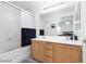 Bright bathroom features double sink vanity and bathtub with sliding glass door at 5043 Naff Ridge Dr, Las Vegas, NV 89131
