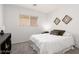 Cozy bedroom with a white bed set, artwork, and window at 5043 Naff Ridge Dr, Las Vegas, NV 89131